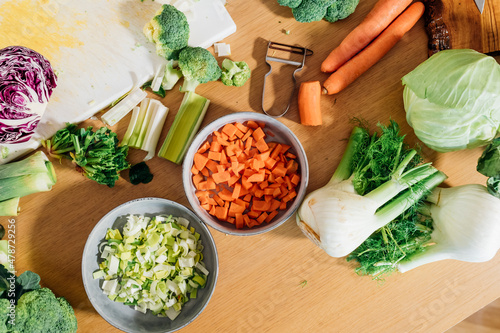 Chopped and sliced fresh vegetables on table at home photo