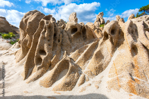 Italy, Province of South Sardinia, Villasimius, Eroded sandstone rock formations on beach photo