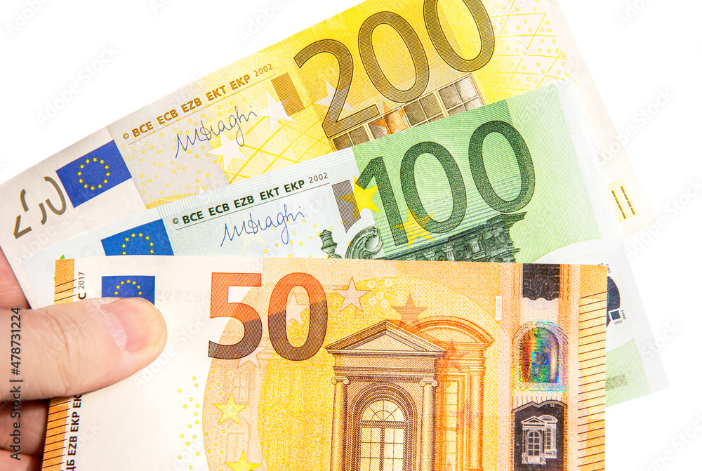 Banknotes of Euro currency in hand on white background Banknotes of Euro currency in hand on white background