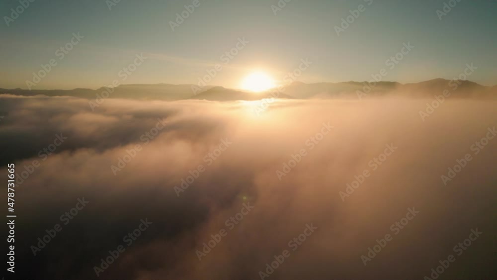 Drone Aerial View Flying Above Beautiful Heavenly Clouds During Epic Warm Sunrise With Mountains In Background. Camera Flying Right. Drone Aerial View Flying Above Beautiful Heavenly Clouds During Epic Warm Sunrise With Mountains In Background. Camera Flying Right.