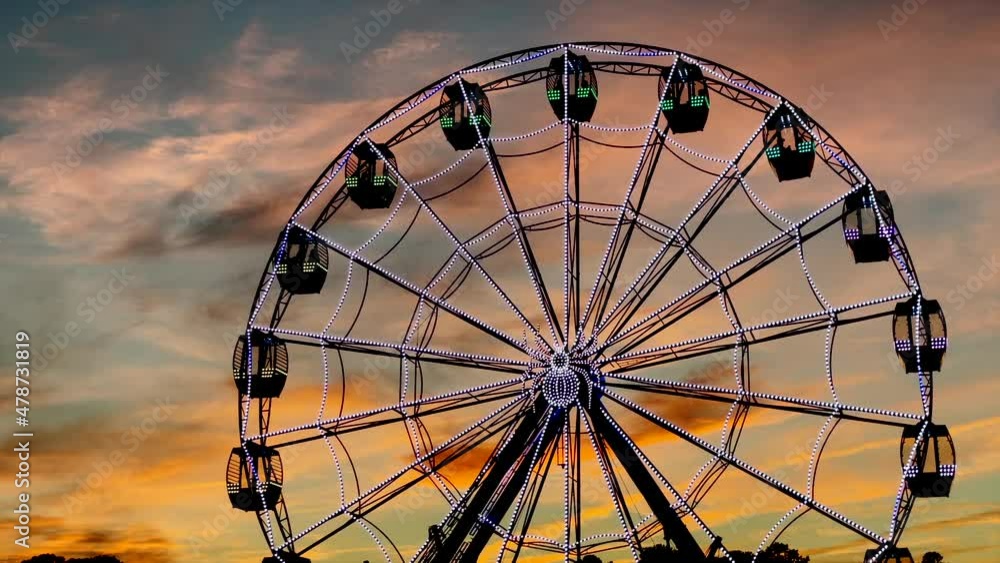 Beautiful sunset with big wheel Carnival spinning Beautiful sunset with big wheel Carnival spinning