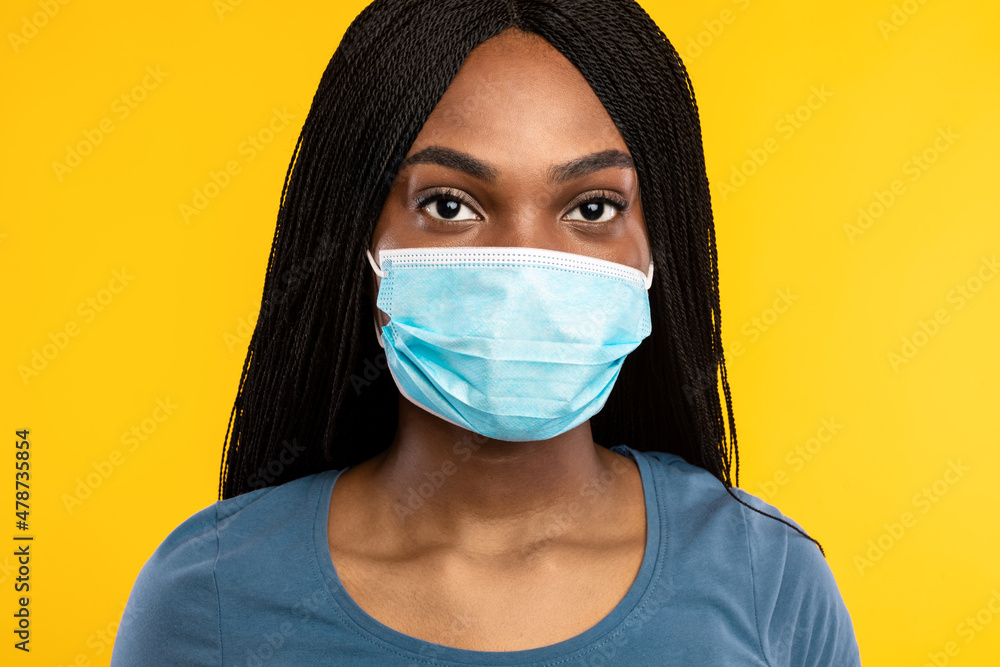Black Millennial Lady Wearing Face Mask Over Yellow Studio Background Black Millennial Lady Wearing Face Mask Over Yellow Studio Background