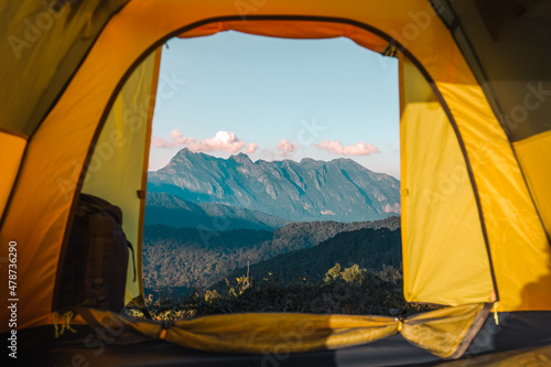 Yellow tent on the mountain and sunset view