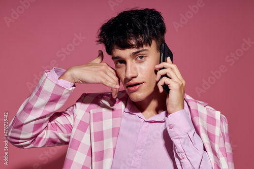 handsome guy with a phone in hand pink blazer fashion elegant style Lifestyle unaltered © Tatiana