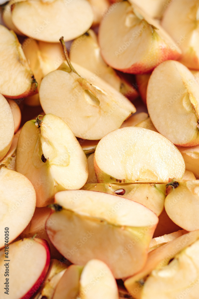 Sliced apples fruit. Vertical close-up view of many slices of cut apples Sliced apples fruit. Vertical close-up view of many slices of cut apples