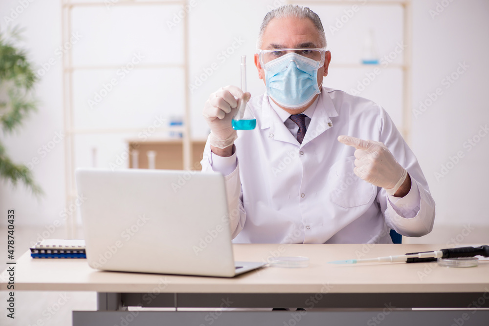 Old male chemist working in the lab during pandemic Old male chemist working in the lab during pandemic