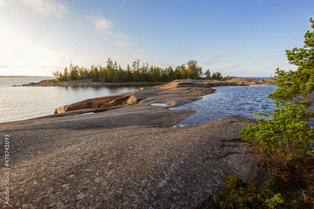 Small pond on a cliff by the sea at Geta in Åland Islands, Finland, on a sunny day in the summer.
