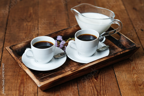 Two espresso cups on a wooden table. Morning coffee. Breakfast with coffee. Wooden table.