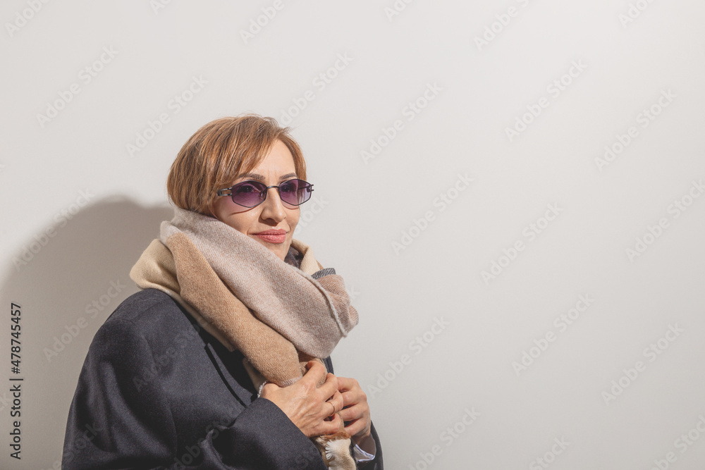 Beautiful baby boomer woman of middle age in sunglasses smile and
