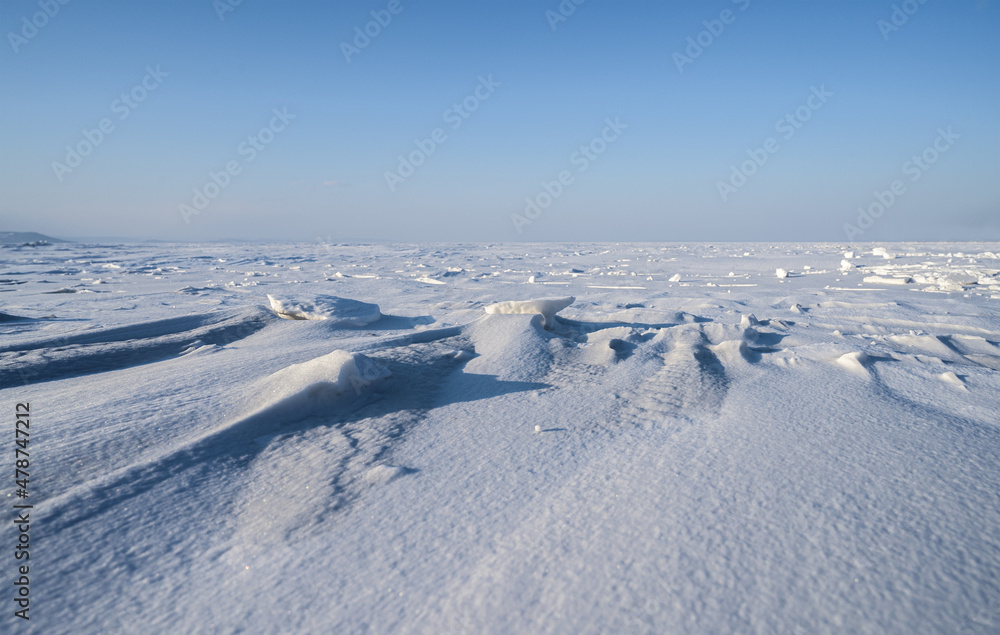 Winter landscape - frozen sea surface with snow.