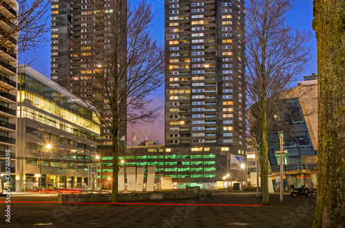 Rotterdam, The Netherlands, January 6, 2022: downtown Willemsplein square, surrounded by offices, residential towers and parking garages, in the blue hour before sunrise photo