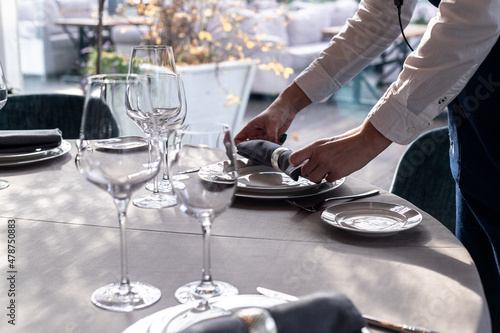table serving with tablewear glasses and plates in restaurant. selected focus photo