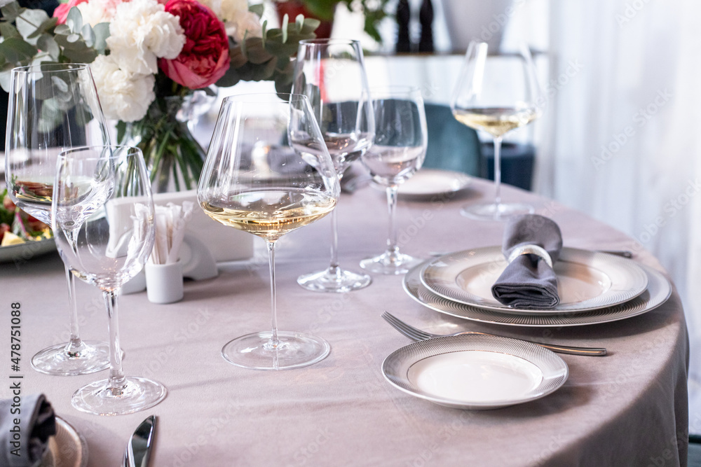 table serving with tablewear glasses and plates in restaurant. selected focus table serving with tablewear glasses and plates in restaurant. selected focus