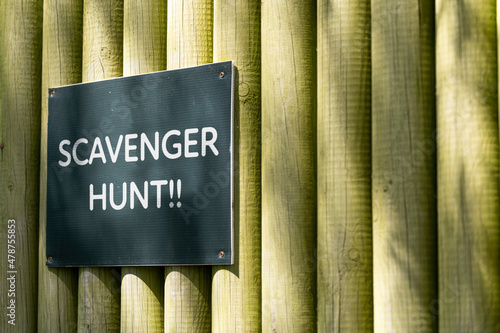 Scavenger hunt sign on wooden background