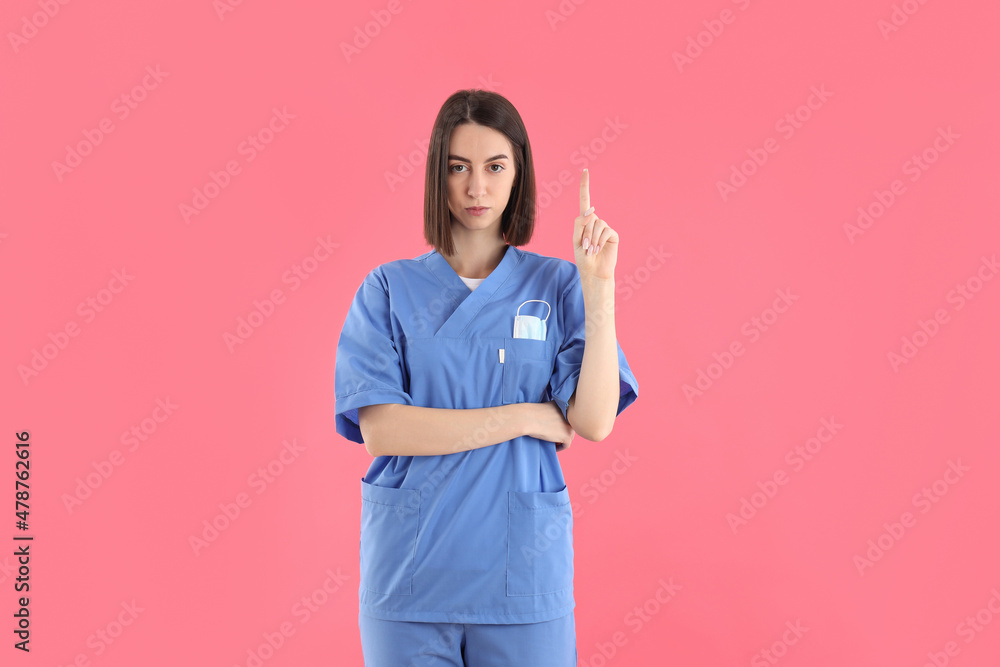 Young female trainee nurse on pink background Young female trainee nurse on pink background
