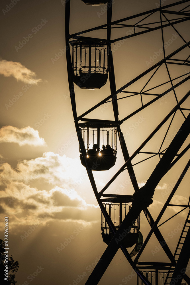 Ferris Wheel on the Beach at Sunset with Golden Sun Rays Ferris Wheel on the Beach at Sunset with Golden Sun Rays