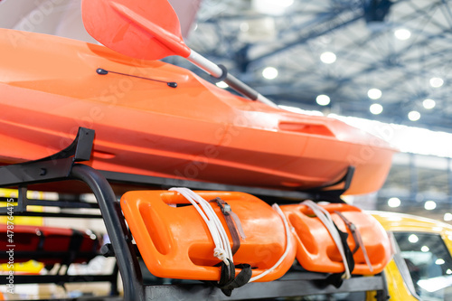 Orange lifeboat on display, paddle. © Angelov