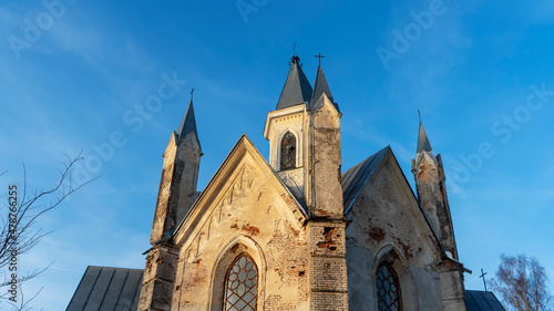 Neo-Gothic style chapel on sunset sky background. Religious concepts.