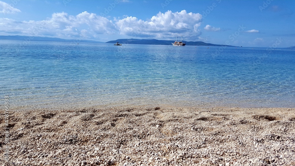blue türkise turcuoise water beach sea side rocks croatia
boats sky clouds