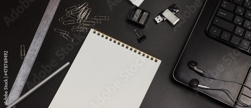 Workspace. Office black desk with stationery. Dark background. Flat lay