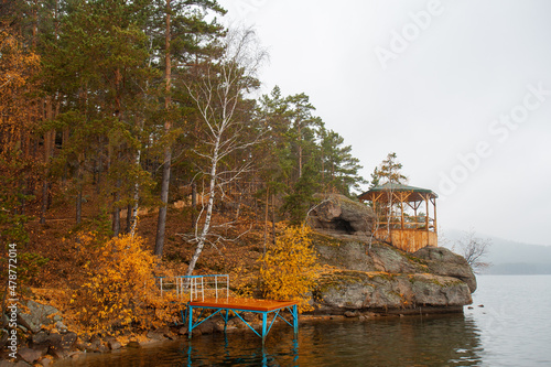 Gazebo on the rocks and wooden bridge by the lake. Autumn time in Burabay National Park, Aqmola Region, Kazakhstan. photo