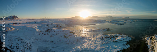 Aerial drone view of panoramic sunset of snow and ice covered Norway Andøya close to Andenes