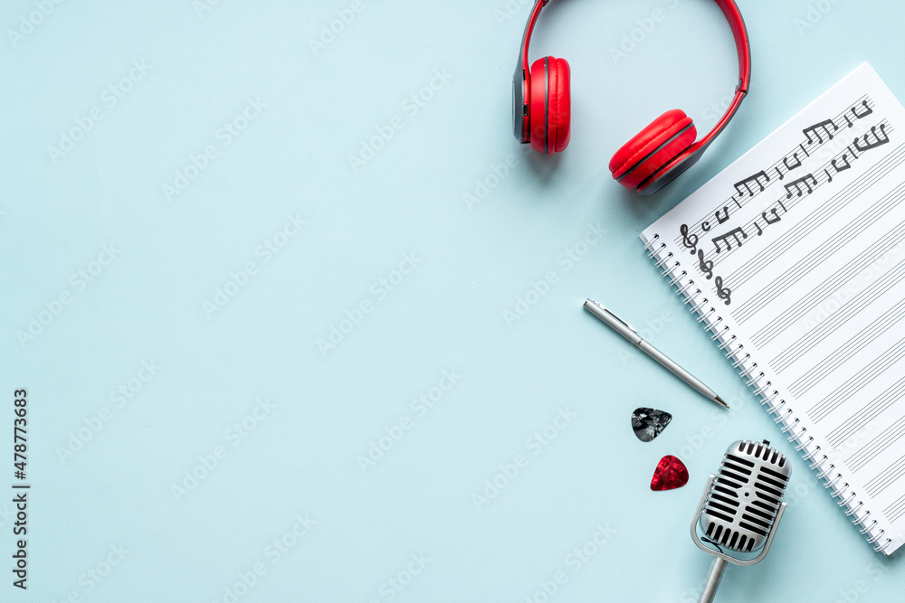Sheets with music notes and headphones. Compose music concept Sheets with music notes and headphones. Compose music concept