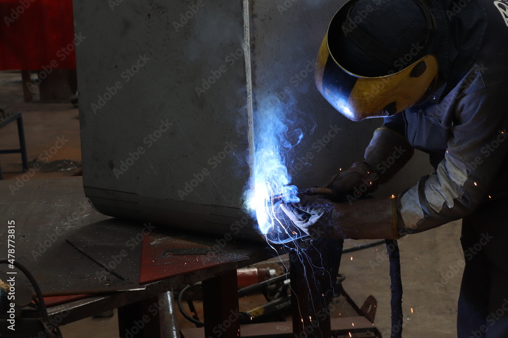 The man welding in the factory The man welding in the factory