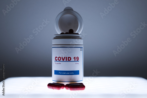 A white bottle of covid-19 antiviral pills in the laboratory. Concept of the new antiretroviral treatment pill Covid-19.