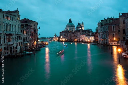 Late evening canals with boats, lanterns and motion blurs in dark. Venice. © radiokafka