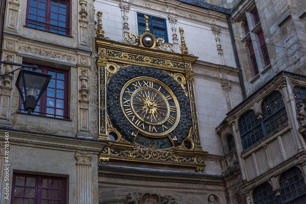 Large golden clock on side of gothic church Large golden clock on side of gothic church