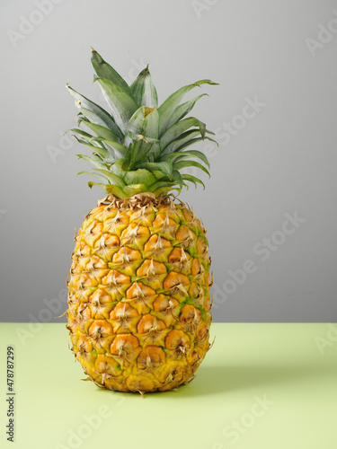 Single whole pineapple isolated on colored background. Copy space. Space for text. Close up. 