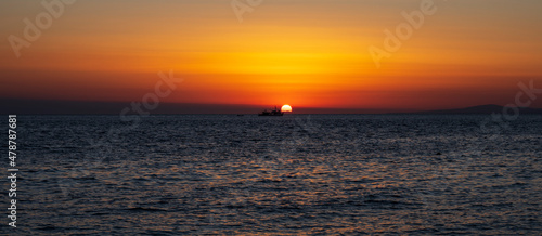 Silhouette of boat on sea beach with sunset background. Sunset moment at the sea side in Neos Marmaras  Greece.