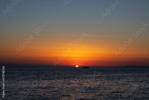 Silhouette of boat on sea beach with sunset background. Sunset moment at the sea side in Neos Marmaras  Greece.
