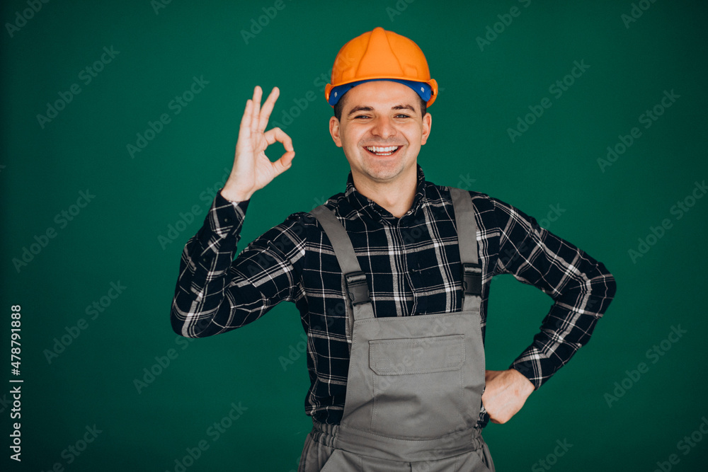 Man worker in hard hat isolated on green background