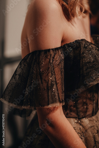 Billede på lærred An elegant detail of an evening black glittering designer dress on a female figu