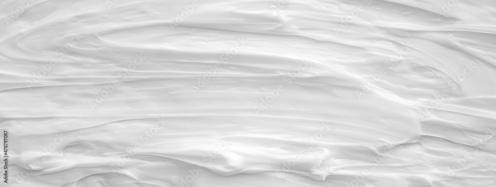Fototapeta premium White surface of the cream lotion softens the background.
