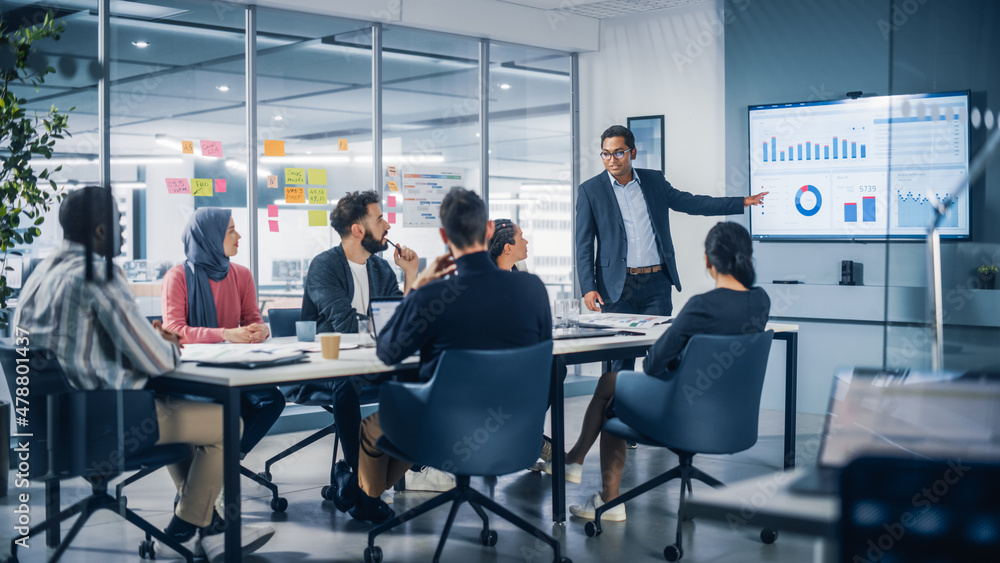 © Gorodenkoff - Presentation in Multi-Ethnic Office Conference Room. Meeting of Diverse Young Entrepreneurs, Specialists, Talking, Using TV for infographics. Businesspeople Develop e-Commerce Startup. © Gorodenkoff - Presentation in Multi-Ethnic Office Conference Room. Meeting of Diverse Young Entrepreneurs, Specialists, Talking, Using TV for infographics. Businesspeople Develop e-Commerce Startup.