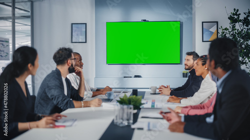 Fotografie Multi-Ethnic Office Conference Room Meeting: Diverse Team of Successful Managers, Executives Talk, Use Green Screen Chroma Key TV