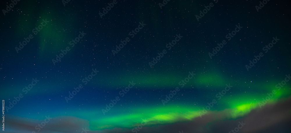 Northern Lights also known as aurora, borealis or polar lights at cold night over igloo village. Beautiful night photo of magic nature of winter landscape