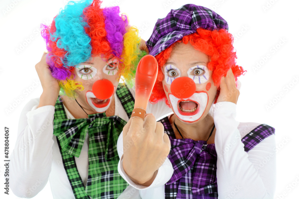 Two clowns with red nose, costume and wig are silly and funny Two clowns with red nose, costume and wig are silly and funny