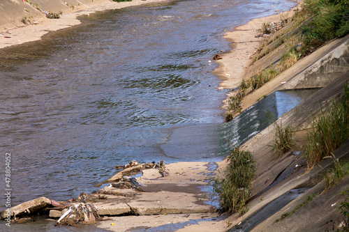 Traveling through the city canals of the Guaire river, its waters are waste and accumulate all the wastes of the industry and the Caracas population photo