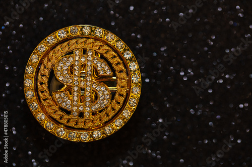 golden dollar sign with gemstones on black  glitter background © Ruslan
