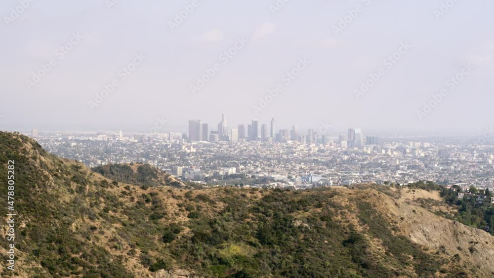 Aerial Slowly Panning Hills With A Thick Haze And Downtown Skyline In The Distance - Los Angeles, California Aerial Slowly Panning Hills With A Thick Haze And Downtown Skyline In The Distance - Los Angeles, California
