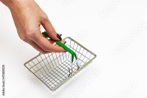 Fényképezés grubby hand holds an empty miniature grocery basket