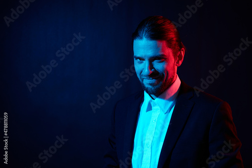 portrait of a man in costume posing fashion dark background