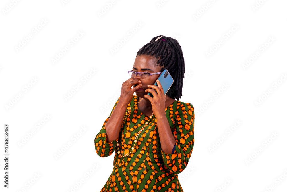 portrait of a beautiful mature woman on cellphone and holding nose. portrait of a beautiful mature woman on cellphone and holding nose.