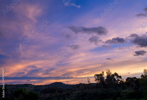 Multiple exposure composite of colorful soft clouds at west at sunrise  in the eastern Andes range in central Colombia near the colonial town of Villa de Leyva.