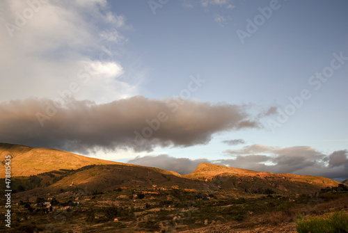 A little gray cloud hangs over a segment of the eastern Andes range near the colonial town of Villa de Leyva in central Colombia at sunset.