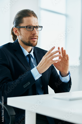 male manager with glasses works in an office or computer